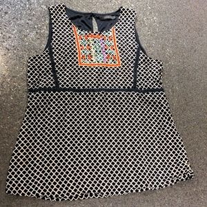 Sleeveless blouse with embroidered detail.